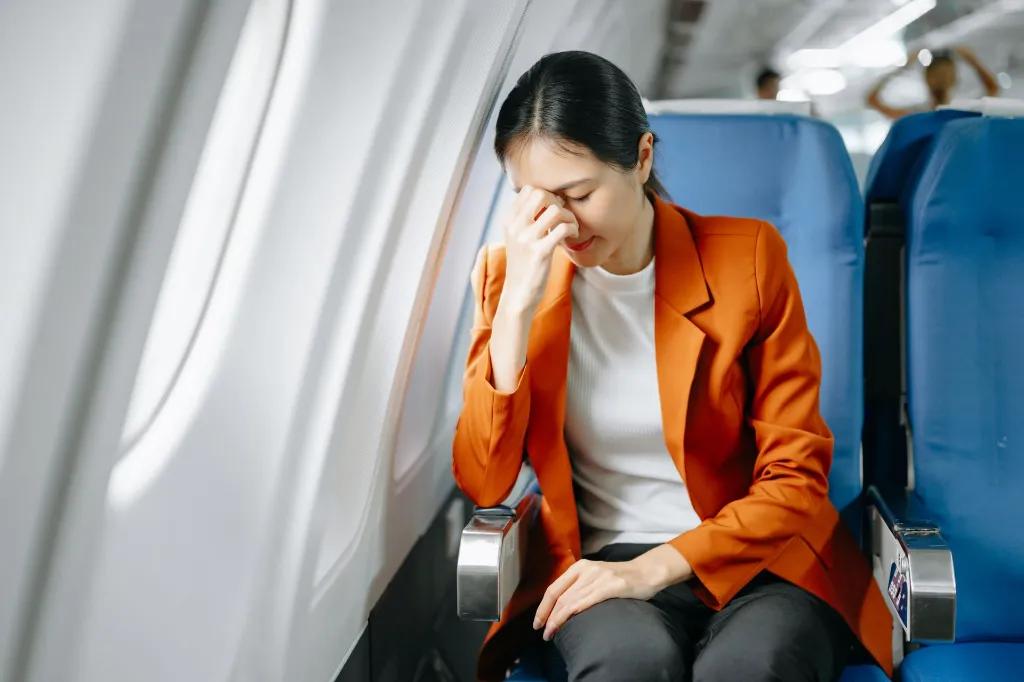 photo-of-a-frustrated-woman-sitting-on-an-airplane-2026-03-11-00-50-11-utc.webp